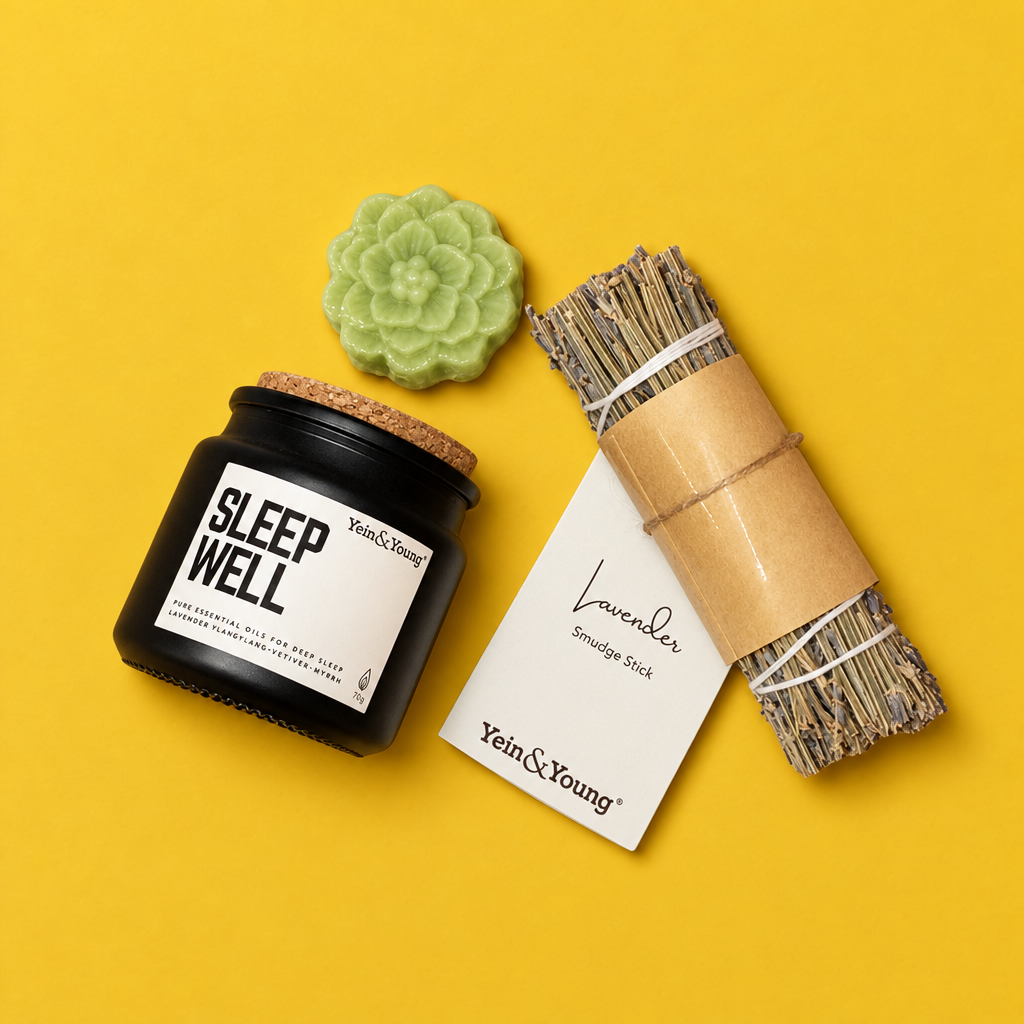 Yein & Young Sleep Well candle jar shown with a green flower-shaped wax melt, a lavender smudge stick bundle wrapped in kraft paper, and a branded card on a white background with descriptive text callouts.
