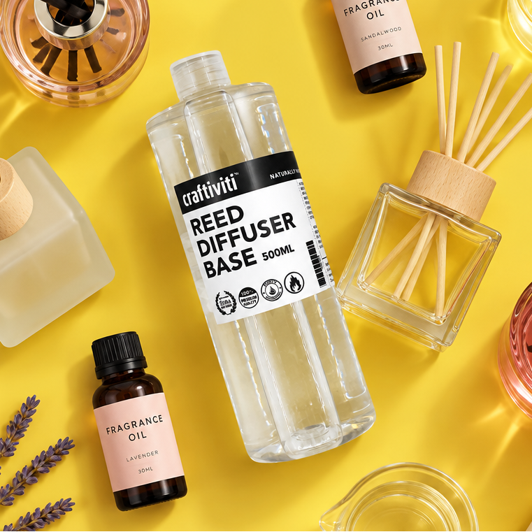 Craftiviti Reed Diffuser Base 500ml bottle in the center, surrounded by fragrance oil bottles, a reed diffuser with wooden sticks, and glass containers on a bright yellow background.