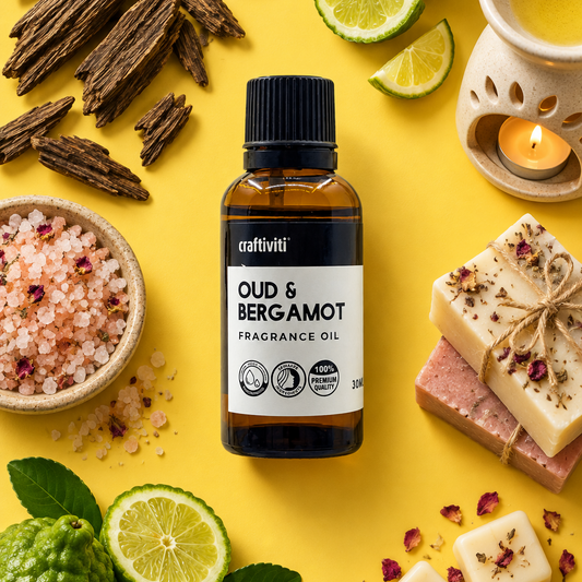 A bottle of craftiviti Oud & Bergamot Fragrance Oil is centered on a bright yellow background, surrounded by natural ingredients and scent-themed props including bergamot fruits, lime slices, dried bark, bath salts, scented bars, and a small candle.