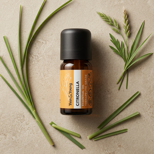 A small amber glass bottle of Yein & Young Citronella essential oil with a black cap and an orange label, shown on a plain white background.