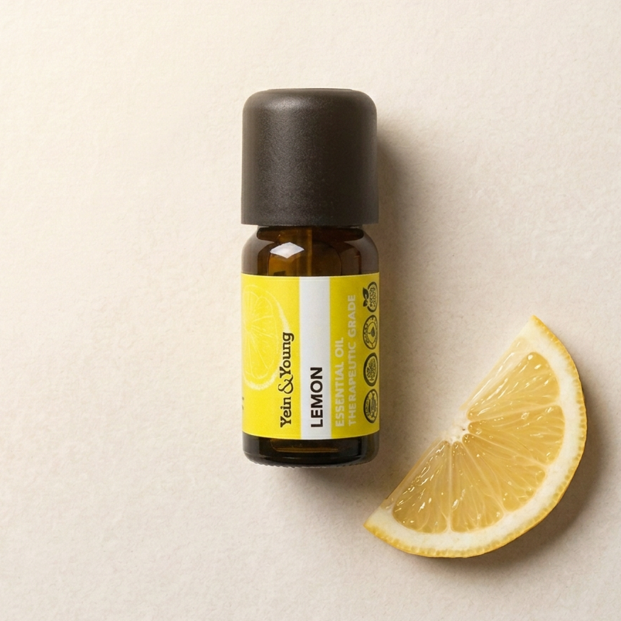 A 10ml bottle of Yein&Young Lemon Essential Oil with a black cap and a label that includes the product name and a graphic representing a lemon.