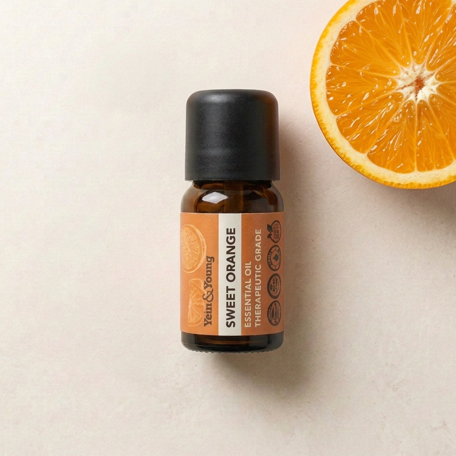 A 10ml bottle of Yein&Young Sweet Orange Essential Oil with a black cap and a label that includes the brand name, product name, and the fact that it is therapeutic grade.